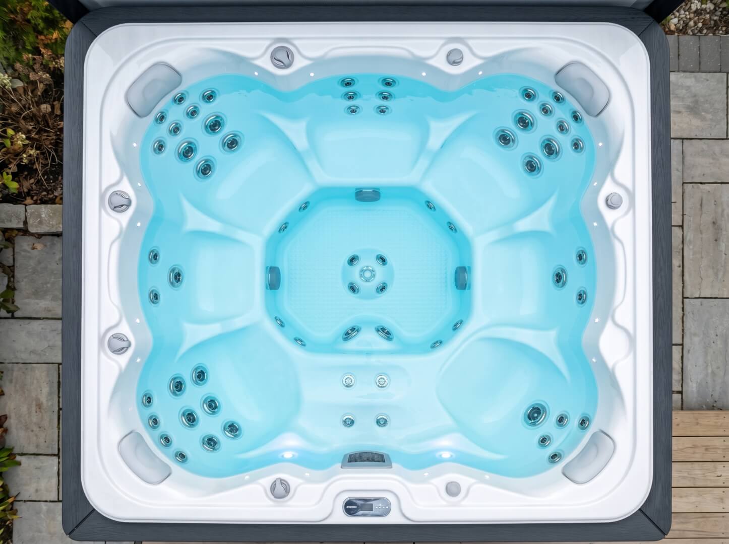 Interior of The Cove outdoor spa showing hydrotherapy jets, seating and LED lighting — OxiusPro