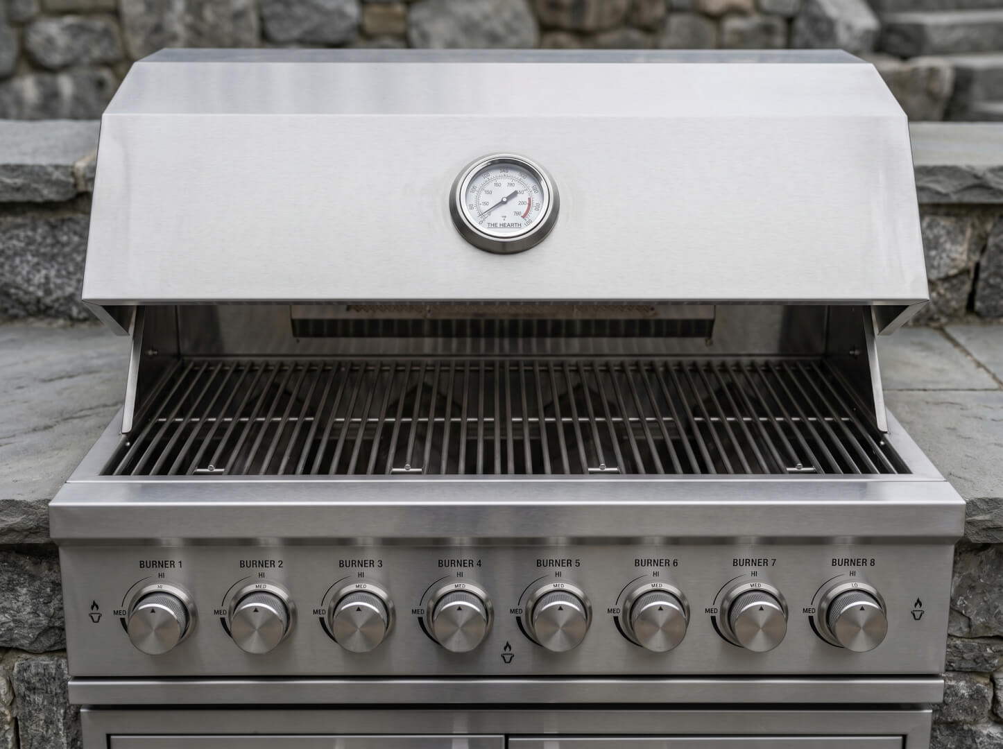 8-zone gas burner grill detail on The Hearth outdoor kitchen in brushed stainless steel — OxiusPro