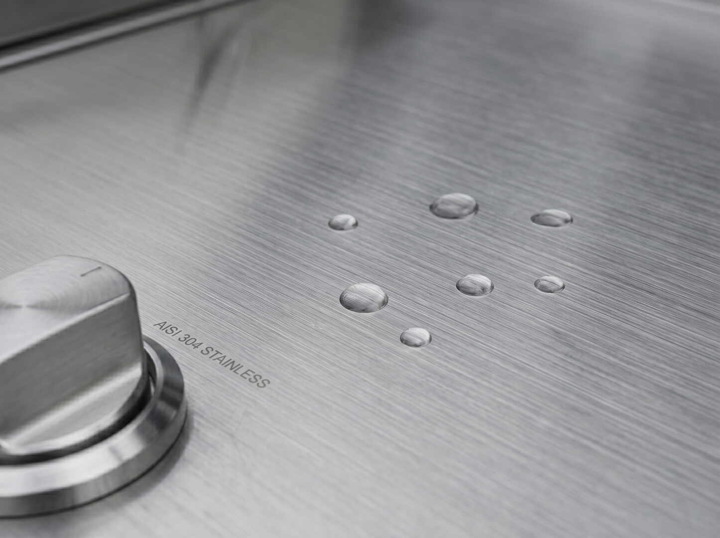 Brushed 304 stainless steel worktop and cabinet panel detail on The Hearth outdoor kitchen — OxiusPro