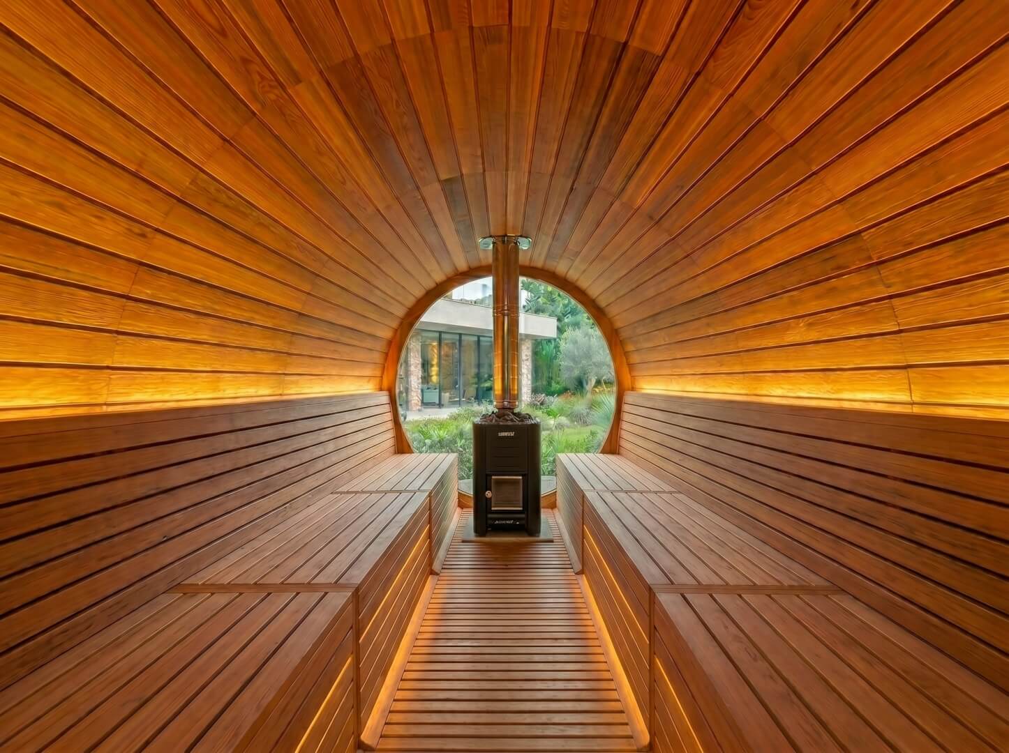 Interior of The Horizon barrel sauna showing cedar benches and heater — OxiusPro