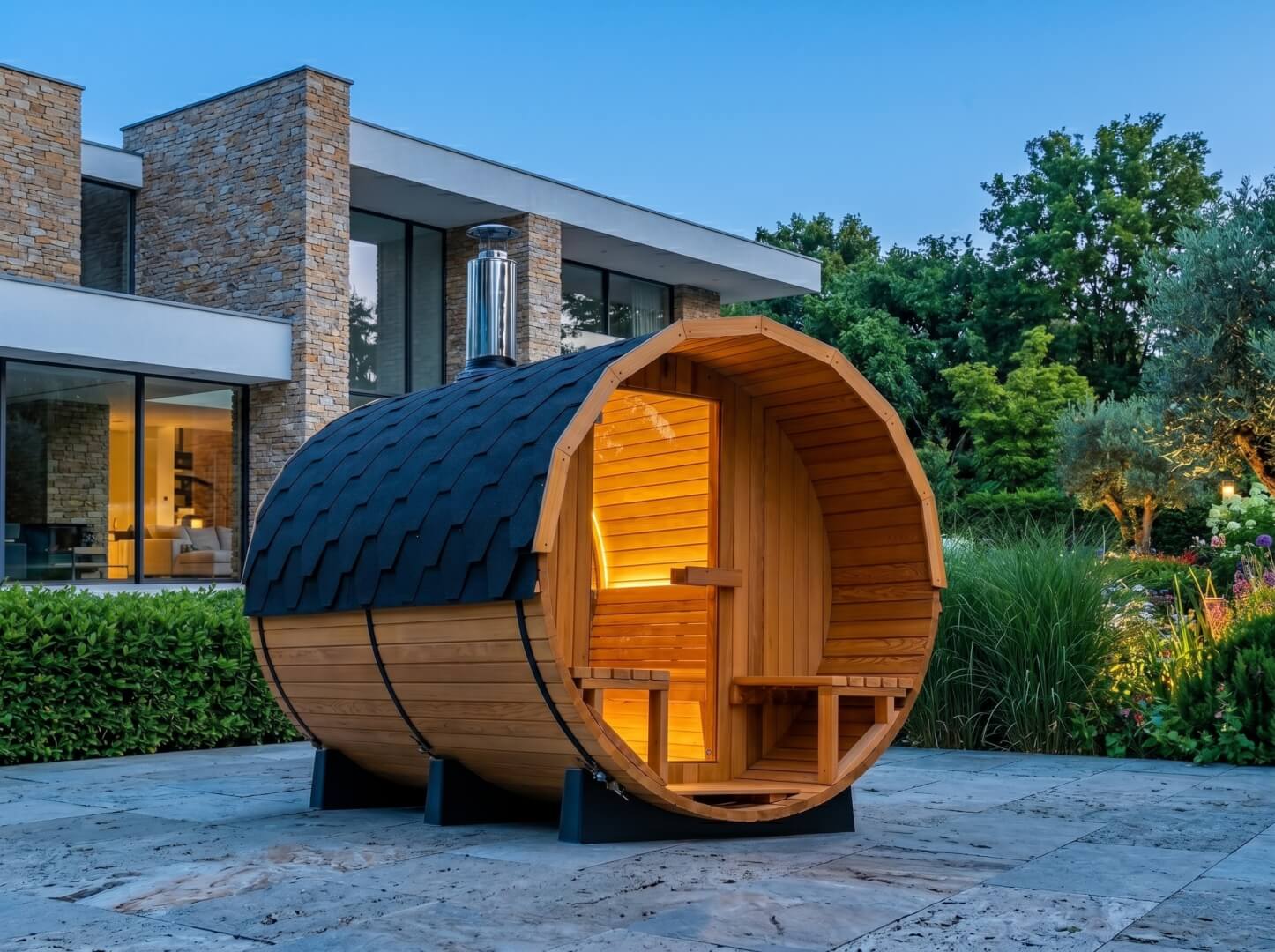 The Horizon outdoor barrel sauna in Canadian Red Cedar installed on a modern stone terrace — OxiusPro