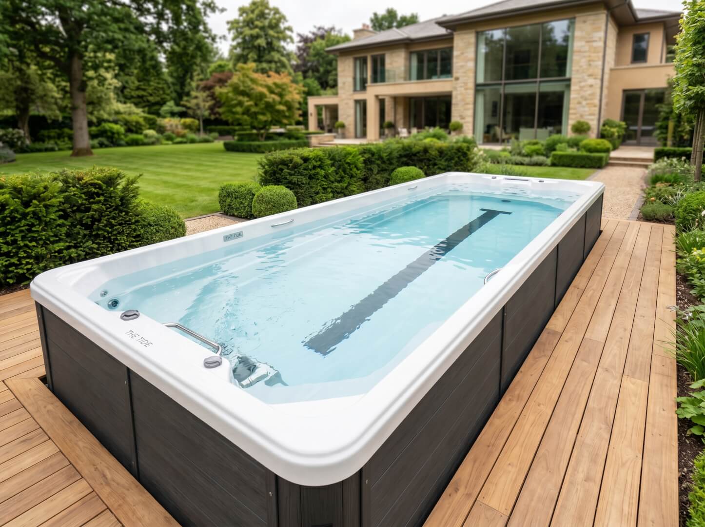 The Tide swim spa installed in a landscaped estate garden — OxiusPro